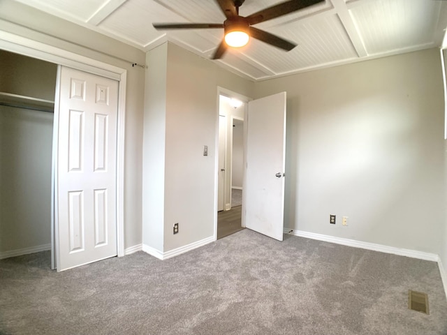 unfurnished bedroom featuring a closet, carpet flooring, visible vents, and baseboards