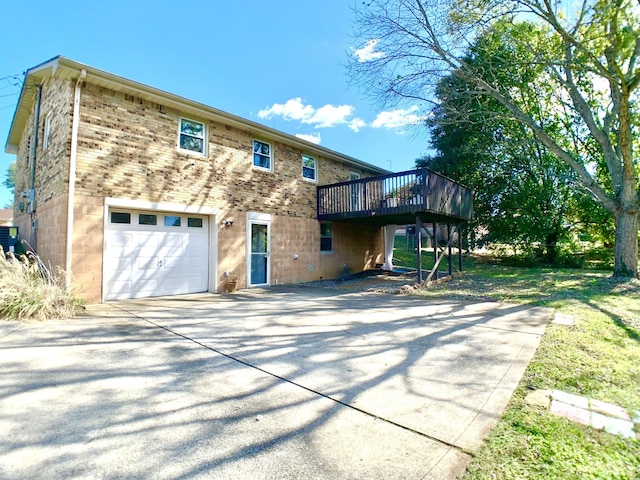 exterior space featuring a deck, concrete driveway, brick siding, and cooling unit