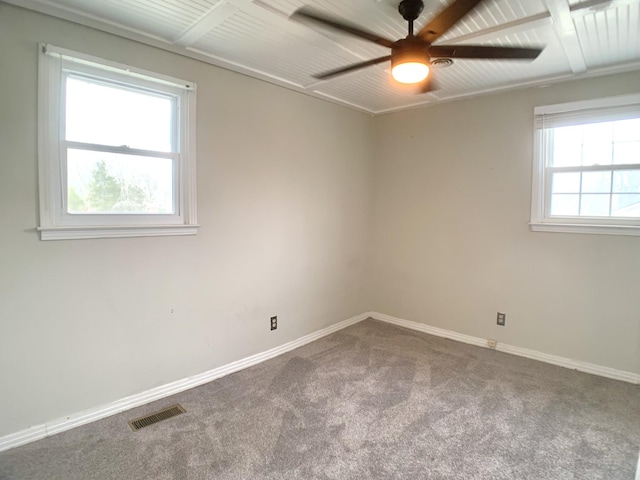 unfurnished room with a ceiling fan, carpet flooring, visible vents, and baseboards