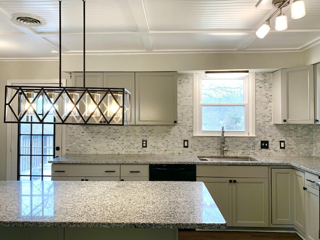 kitchen featuring dishwasher, tasteful backsplash, light stone counters, and a sink