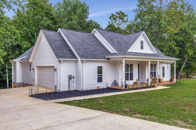 view of front of home with covered porch, a garage, a shingled roof, concrete driveway, and a front yard