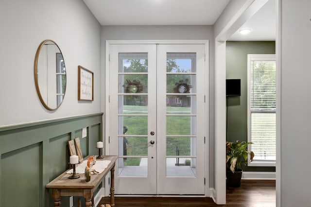 doorway with dark wood-style floors, french doors, and baseboards