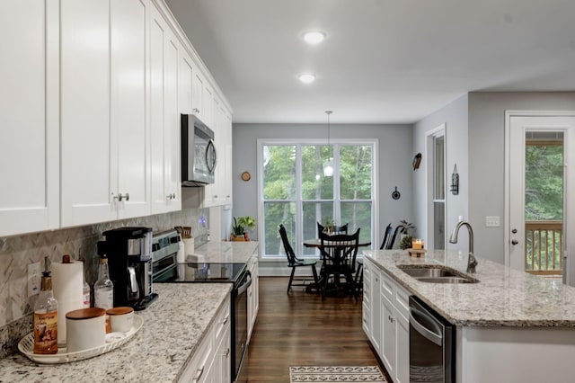 kitchen with electric range, a sink, white cabinets, dishwasher, and stainless steel microwave