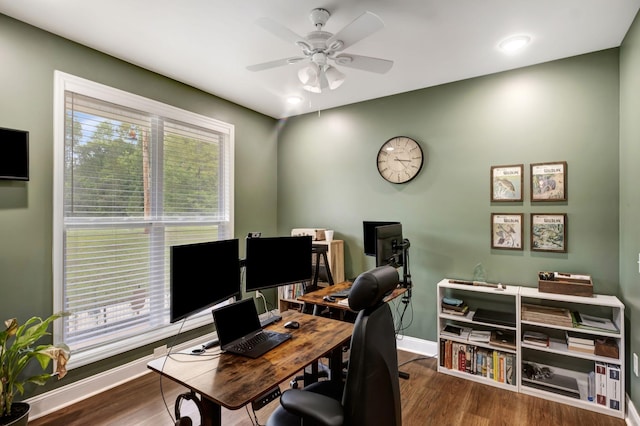 home office with dark wood-style floors, ceiling fan, and baseboards