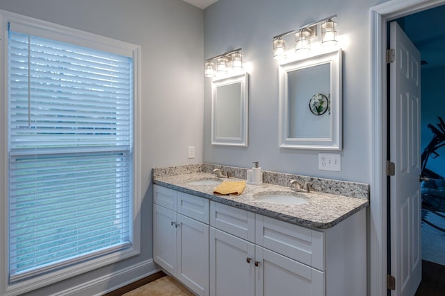 bathroom with double vanity and a sink