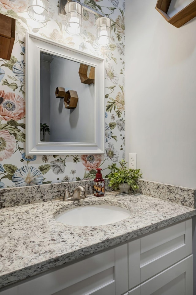 bathroom featuring wallpapered walls and vanity