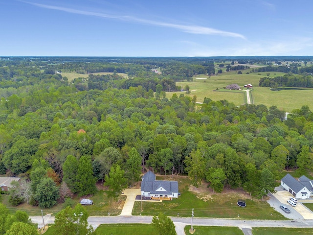 birds eye view of property with a view of trees