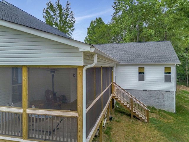 exterior space featuring crawl space, a sunroom, a shingled roof, and stairway