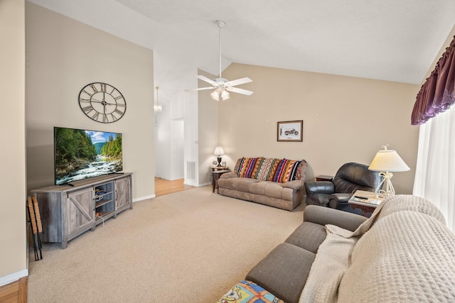 carpeted living area featuring lofted ceiling, visible vents, a ceiling fan, and baseboards