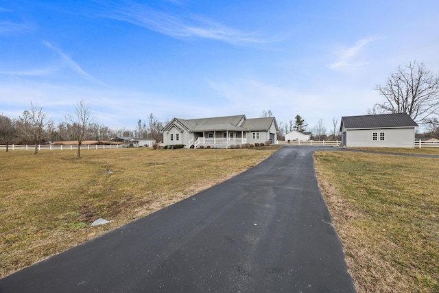 view of front of property with a porch, a front lawn, and fence