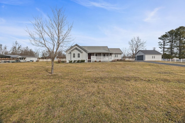 view of front of house with covered porch, fence, and a front yard