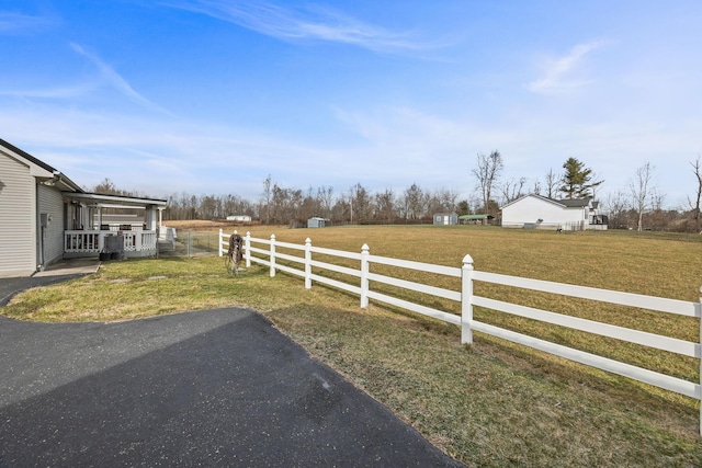 view of yard with a rural view and fence