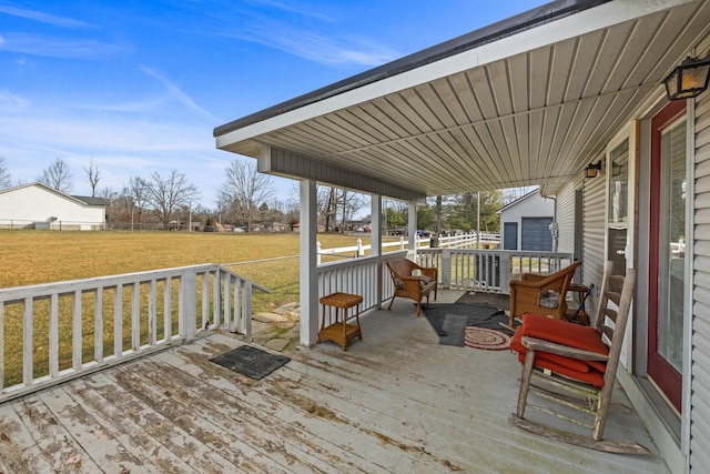 wooden deck featuring fence and a lawn