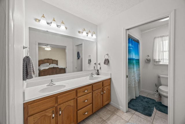 full bath with a sink, tile patterned flooring, a textured ceiling, and connected bathroom