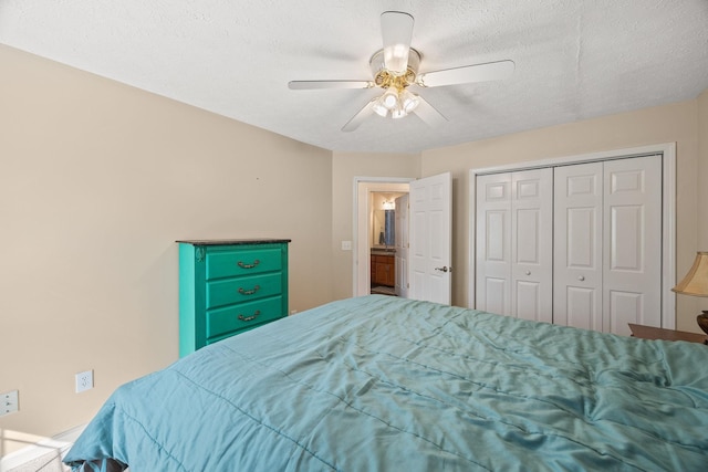 bedroom with ceiling fan, a closet, and a textured ceiling