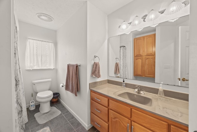 bathroom featuring toilet, a textured ceiling, vanity, baseboards, and tile patterned floors