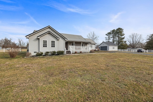 view of front of home featuring covered porch, crawl space, a detached garage, and a front yard