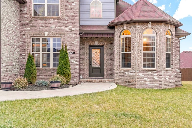 1220 Forsythia Ct, Clarksville, TN 37043 - property entrance with a yard, brick siding, and a shingled roof