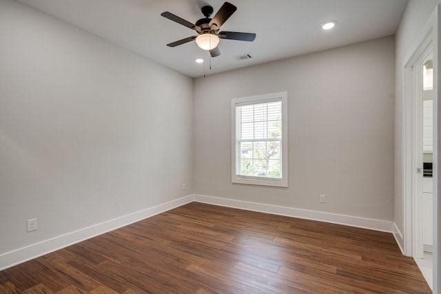 empty room with recessed lighting, dark wood-style flooring, visible vents, and baseboards