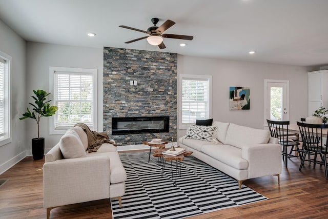 living area with a fireplace, baseboards, dark wood finished floors, and recessed lighting