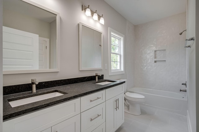 bathroom featuring double vanity, shower / bath combination, a sink, and tile patterned floors