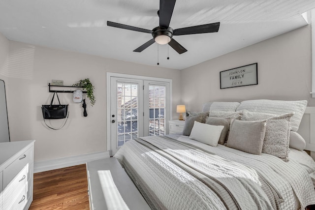 bedroom featuring a ceiling fan, access to outside, baseboards, and wood finished floors