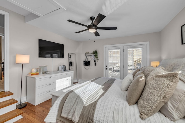 bedroom featuring access to exterior, light wood-style flooring, and a ceiling fan