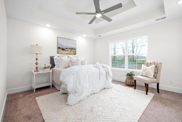 carpeted bedroom with recessed lighting, a raised ceiling, visible vents, ceiling fan, and baseboards