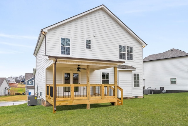 back of property featuring ceiling fan, a yard, and cooling unit