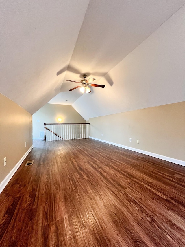 bonus room with visible vents, a ceiling fan, vaulted ceiling, wood finished floors, and baseboards