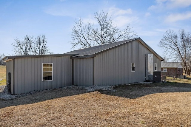 view of side of property featuring metal roof