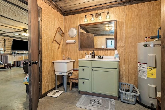 bathroom with water heater, ceiling fan, wooden walls, vanity, and unfinished concrete floors