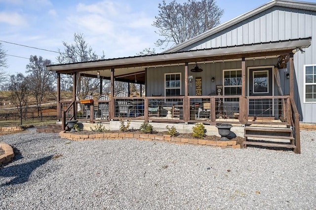 exterior space with covered porch, metal roof, and board and batten siding