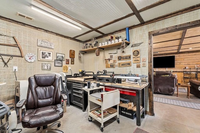 office with concrete flooring, a workshop area, and visible vents