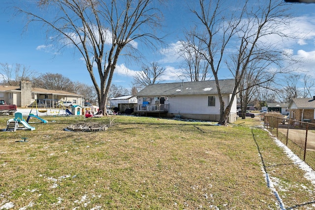 view of yard featuring a playground and fence