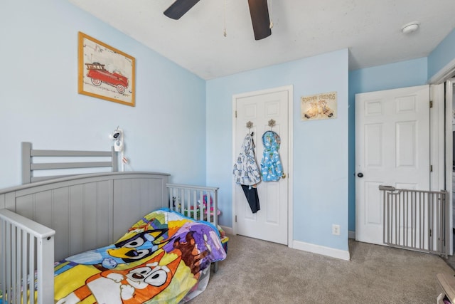 bedroom with light carpet, radiator heating unit, baseboards, and ceiling fan