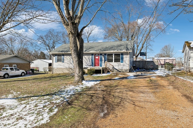 view of front of property with a lawn and fence