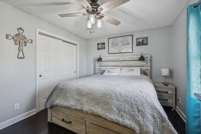 bedroom with ceiling fan, a closet, baseboards, and dark wood-style flooring