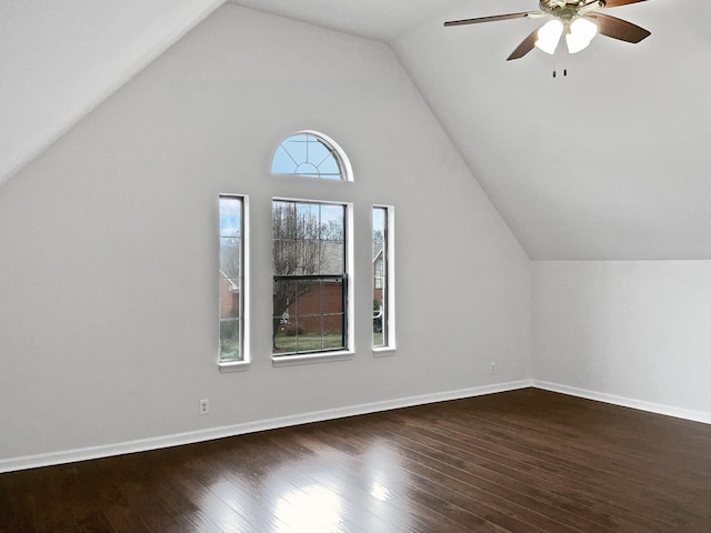 bonus room with dark wood-style floors, lofted ceiling, and baseboards