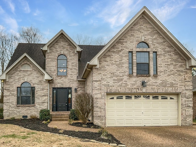 french country inspired facade featuring crawl space, roof with shingles, a garage, and brick siding