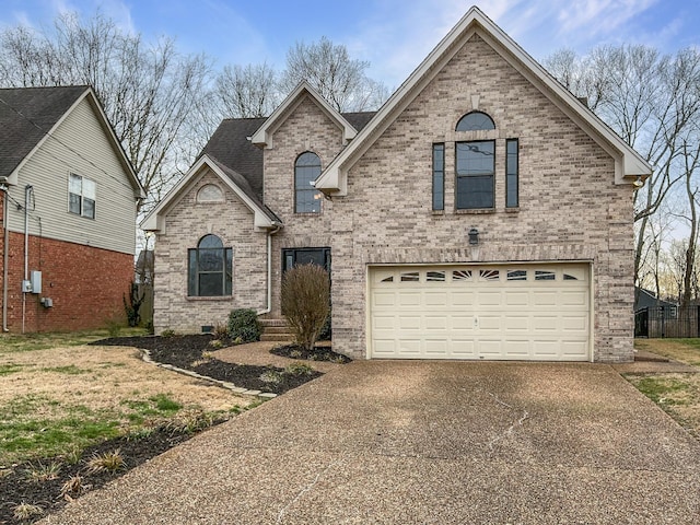 view of front of house with a garage, driveway, brick siding, and crawl space