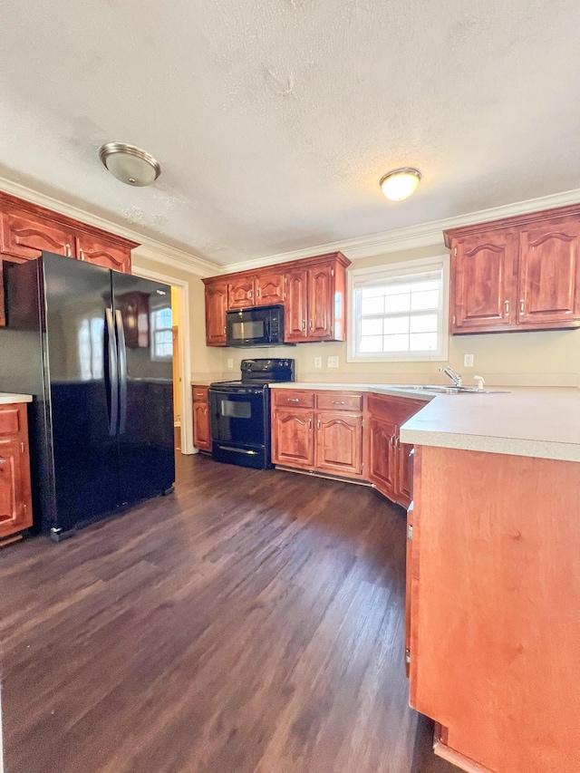 kitchen featuring dark wood finished floors, brown cabinetry, light countertops, crown molding, and black appliances