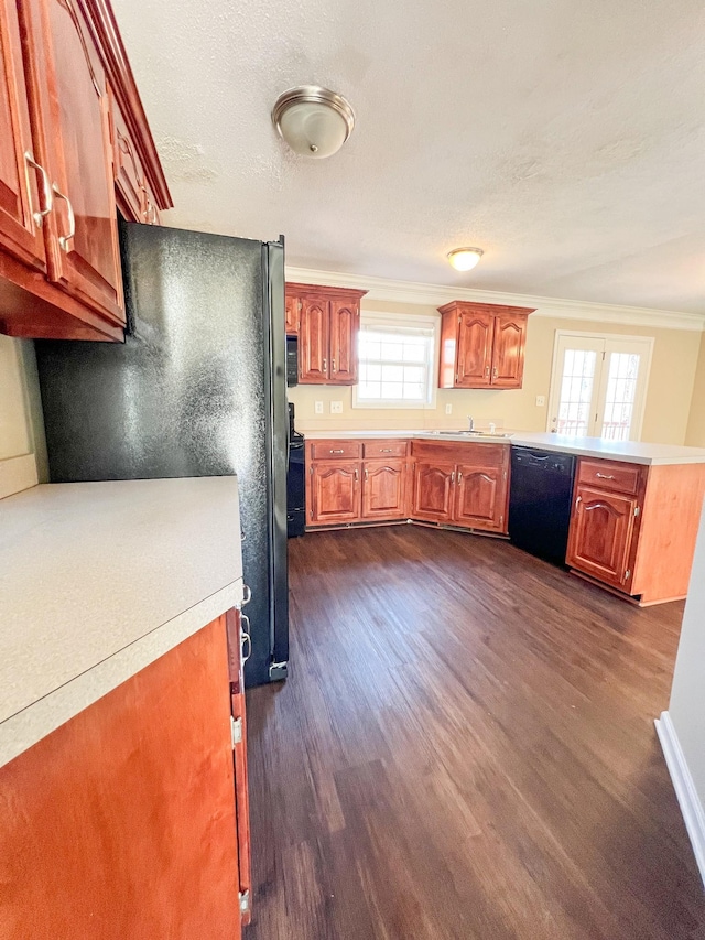 kitchen featuring black appliances, light countertops, and dark wood-type flooring