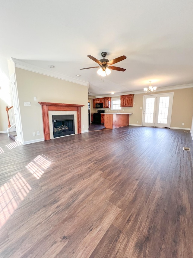 unfurnished living room featuring dark wood finished floors, a fireplace, crown molding, and baseboards