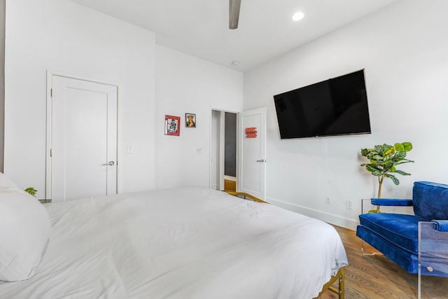 bedroom with a ceiling fan, recessed lighting, baseboards, and wood finished floors