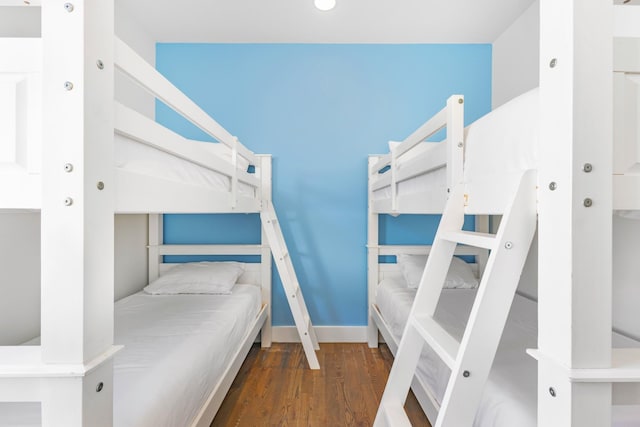 bedroom with baseboards and dark wood finished floors