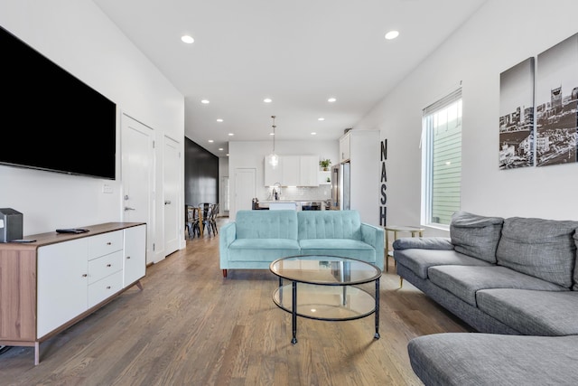 living room with dark wood finished floors and recessed lighting