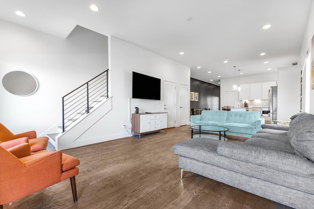 living room with dark wood-style floors, stairway, baseboards, and recessed lighting