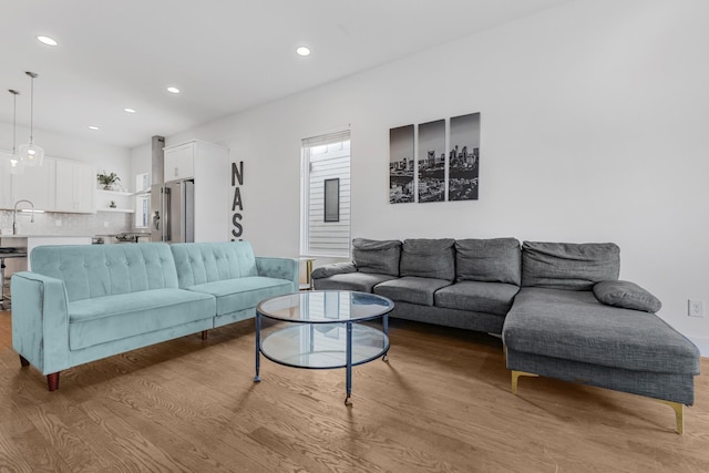 living area with recessed lighting and light wood finished floors