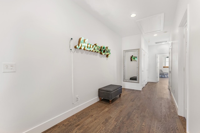 hallway featuring dark wood-type flooring, recessed lighting, attic access, and baseboards